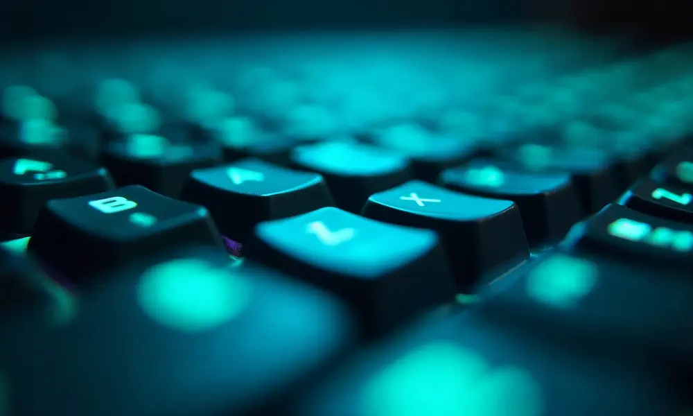 Abstract luminous neural threads forming a halo above a keyboard.